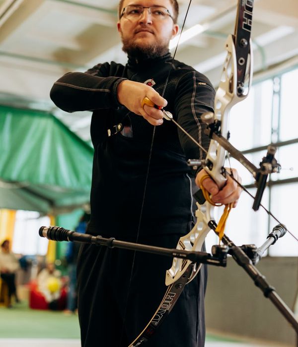 Man performing a bodyweight strength exercise in a bright, modern space.